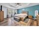 Primary bedroom with a tray ceiling, a ceiling fan, and stylish furnishings at 384 Old Alemany Pl, Oviedo, FL 32765