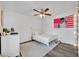 Bedroom with a white metal frame bed and a US flag poster and decorative lighting at 384 Old Alemany Pl, Oviedo, FL 32765