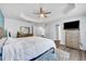 Primary bedroom with a tray ceiling, wood floors and stylish furnishings at 384 Old Alemany Pl, Oviedo, FL 32765