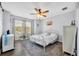 This bedroom has wood flooring, fan, and windows with curtains for natural light at 384 Old Alemany Pl, Oviedo, FL 32765