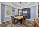 Stylish dining room featuring hardwood floors, a modern light fixture, and ample natural light at 384 Old Alemany Pl, Oviedo, FL 32765