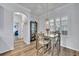 Dining area with bright windows and modern light fixture with seating for four at 384 Old Alemany Pl, Oviedo, FL 32765