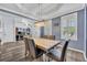 Stylish dining room featuring hardwood floors, a modern light fixture, and ample natural light at 384 Old Alemany Pl, Oviedo, FL 32765