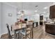 Dining area with modern light fixture open to kitchen and living spaces at 384 Old Alemany Pl, Oviedo, FL 32765