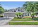 Charming two-story home featuring a well-manicured lawn, a three-car garage, and welcoming curb appeal at 384 Old Alemany Pl, Oviedo, FL 32765