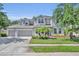 Charming two-story home featuring a well-manicured lawn, a three-car garage, and welcoming curb appeal at 384 Old Alemany Pl, Oviedo, FL 32765