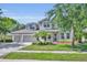 Charming two-story home featuring a well-manicured lawn, a three-car garage, and welcoming curb appeal at 384 Old Alemany Pl, Oviedo, FL 32765