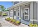Inviting front porch with stylish columns, meticulous landscaping, and a welcoming entrance at 384 Old Alemany Pl, Oviedo, FL 32765