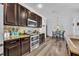 Open concept kitchen features granite countertops, stainless appliances, and eating area at 384 Old Alemany Pl, Oviedo, FL 32765