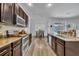Kitchen with granite countertops and stainless appliances that opens to dining room at 384 Old Alemany Pl, Oviedo, FL 32765