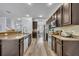 Open kitchen with dark cabinetry, granite countertops and stainless steel appliances at 384 Old Alemany Pl, Oviedo, FL 32765