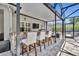 Covered outdoor bar with granite countertops, stone facade, mounted TV, and seating for entertainment at 384 Old Alemany Pl, Oviedo, FL 32765