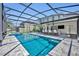 Screened-in pool and spa area with outdoor bar and kitchen, dining area and multiple seating areas at 384 Old Alemany Pl, Oviedo, FL 32765