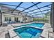 Screened-in pool and spa area with outdoor bar and kitchen, dining area and multiple seating areas at 384 Old Alemany Pl, Oviedo, FL 32765