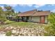 Spacious backyard with lush greenery, a covered porch, and mature trees creating a private outdoor space at 40533 E 8Th Ave, Umatilla, FL 32784