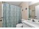 Bathroom featuring a shower with a blue and white patterned curtain and patterned wallpaper at 40533 E 8Th Ave, Umatilla, FL 32784