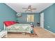 A bedroom featuring blue walls, carpet, and decor with a beach theme at 40533 E 8Th Ave, Umatilla, FL 32784
