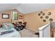 Cozy bedroom with ceiling fan, window, and carpeted floor; decorated with framed pictures and memorabilia at 40533 E 8Th Ave, Umatilla, FL 32784