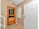 Inviting entryway featuring a charming wooden door, complemented by neutral walls and ample natural light at 40533 E 8Th Ave, Umatilla, FL 32784