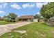 Charming single-story home featuring a long driveway and attached garage on a lush lawn with mature landscaping at 40533 E 8Th Ave, Umatilla, FL 32784