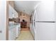 Traditional kitchen features white appliances, matching cabinetry, blue countertops and an adjacent dining room at 40533 E 8Th Ave, Umatilla, FL 32784