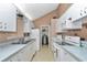 Traditional kitchen features white appliances, matching cabinetry, blue countertops, and a neutral toned backsplash at 40533 E 8Th Ave, Umatilla, FL 32784
