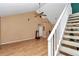Spacious living room with high ceilings, wood laminate flooring and white stairs at 40533 E 8Th Ave, Umatilla, FL 32784
