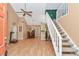 Open concept living space featuring vaulted ceilings, wood laminate floors, staircase, and a kitchen breakfast bar at 40533 E 8Th Ave, Umatilla, FL 32784