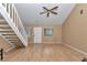 Bright living room with wood laminate flooring, a staircase, and a white front door, offering a welcoming atmosphere at 40533 E 8Th Ave, Umatilla, FL 32784