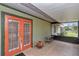Covered porch featuring tile flooring and outdoor seating, ideal for relaxing and enjoying the outdoors at 40533 E 8Th Ave, Umatilla, FL 32784