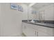 Bathroom featuring a double sink vanity, mirror, and artwork at 4363 Scene Ln, Kissimmee, FL 34746