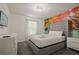 Comfortable bedroom with mural, a plush bed and bright natural light at 4363 Scene Ln, Kissimmee, FL 34746