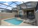 Screened-in pool area with lounge chairs at 4363 Scene Ln, Kissimmee, FL 34746
