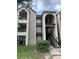 Exterior shot of two-story apartment building with open-air balconies and stairs at 4756 Walden Cir # 21, Orlando, FL 32811