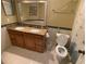 Bathroom boasts a double vanity, granite countertop, tile floors, and ample lighting at 4756 Walden Cir # 21, Orlando, FL 32811