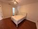 Bedroom featuring wood flooring, a walk-in closet, and a bed frame at 4756 Walden Cir # 21, Orlando, FL 32811