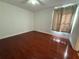Bright bedroom featuring wood flooring, window with curtains, and neutral walls at 4756 Walden Cir # 21, Orlando, FL 32811