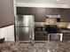 Well-equipped kitchen with stainless steel appliances, granite countertops, and ample cabinet space at 4756 Walden Cir # 21, Orlando, FL 32811