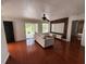 Bright living room with sliding glass doors, sleek wood floors and modern entertainment center at 4756 Walden Cir # 21, Orlando, FL 32811