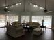 Bright and spacious living room featuring comfortable seating and sliding doors to the pool area at 4756 Walden Cir # 21, Orlando, FL 32811
