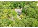 Aerial view showcasing the home's location surrounded by dense, mature trees and a pool at 4933 Round Lake Rd, Apopka, FL 32712