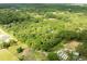 Aerial view of property with a blue location pin, in a densely wooded area, perfect for development at 4933 Round Lake Rd, Apopka, FL 32712