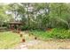A lush backyard featuring a charming red gazebo and a whimsical garden path at 4933 Round Lake Rd, Apopka, FL 32712