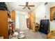 Image of a cluttered bedroom featuring a ceiling fan and neutral carpet at 4933 Round Lake Rd, Apopka, FL 32712