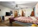 Bedroom with a ceiling fan, en-suite bathroom, and laminate floors at 4933 Round Lake Rd, Apopka, FL 32712