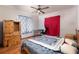This bedroom has light colored wood floors and a ceiling fan at 4933 Round Lake Rd, Apopka, FL 32712