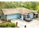 Single story home showcasing light blue exterior with stone accents, a garage, and cozy deck at 4933 Round Lake Rd, Apopka, FL 32712
