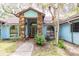 Home featuring a stone accented entrance with an arched window and a light blue exterior at 4933 Round Lake Rd, Apopka, FL 32712