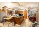 Cluttered kitchen featuring wood cabinets, an island, and standard appliances at 4933 Round Lake Rd, Apopka, FL 32712