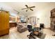 Open-concept living room with tiled flooring, a ceiling fan, and access to the kitchen at 4933 Round Lake Rd, Apopka, FL 32712